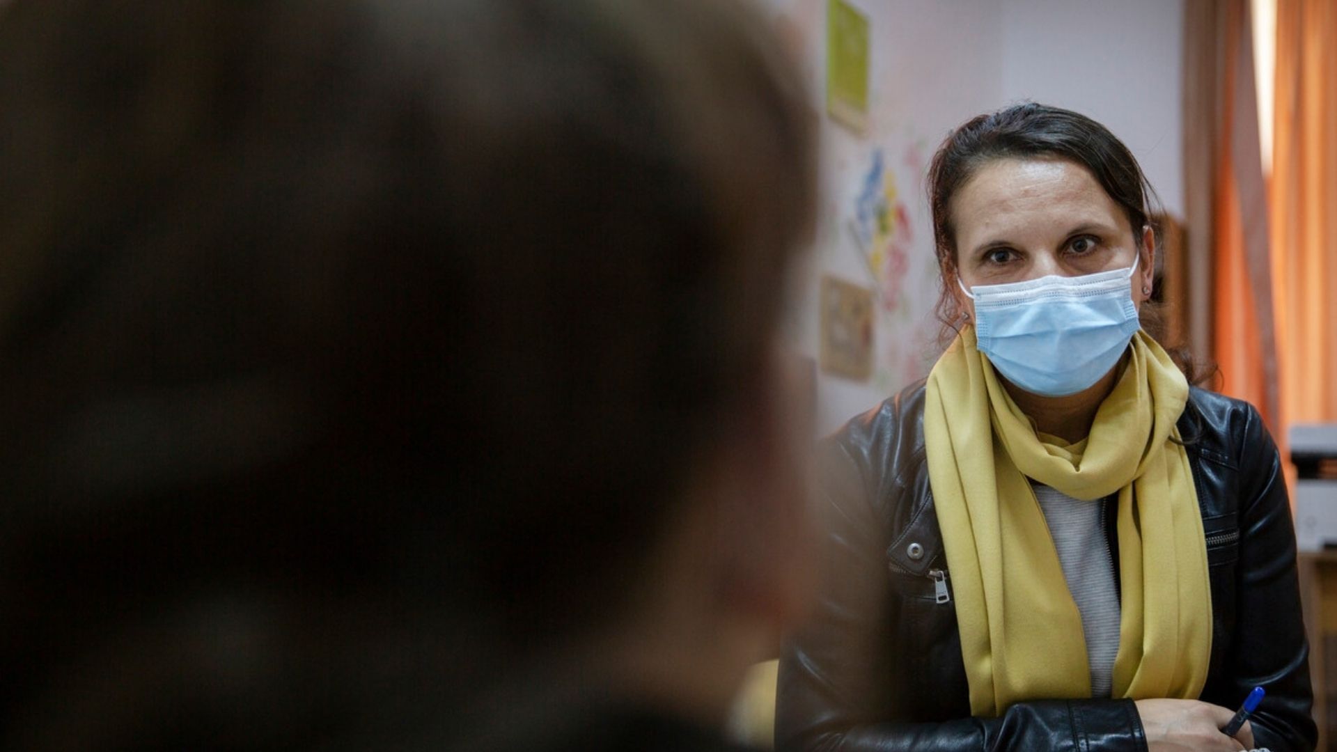 Andrea, one of our social workers, listening to a child