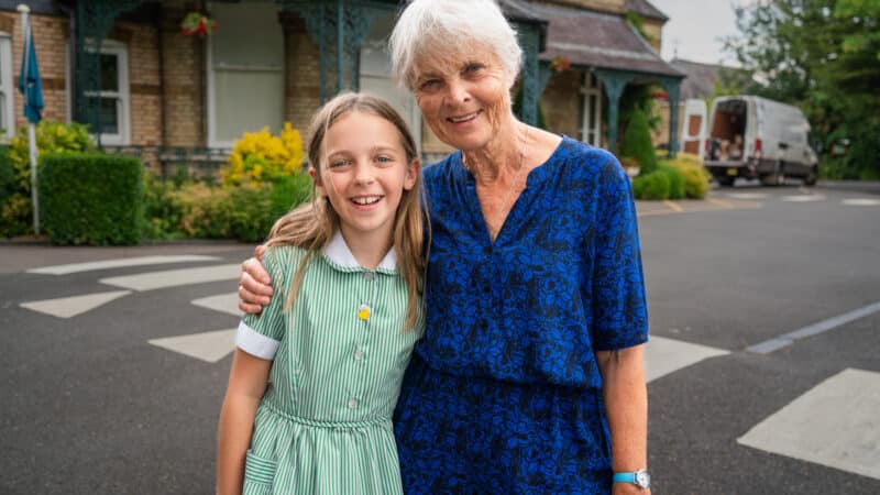 Long-term supporter Wendy and her granddaughter Grace, 11, outside Grace’s school.  Sebastian Solberg / Hope and Homes for Children 