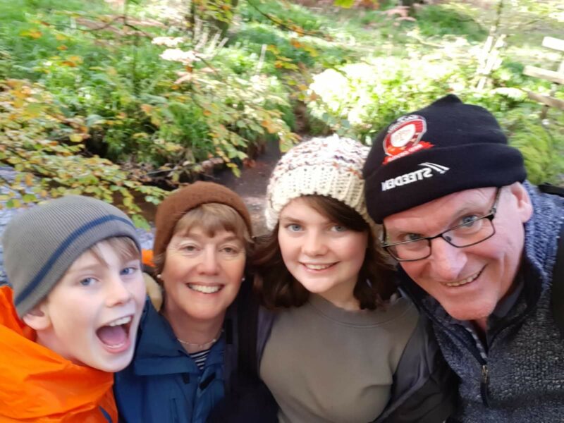 Isobel Noctor and her family smiling after their car boot sale fundraiser